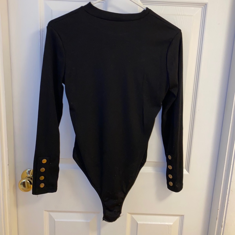 Black bodysuit detailed with gold buttons